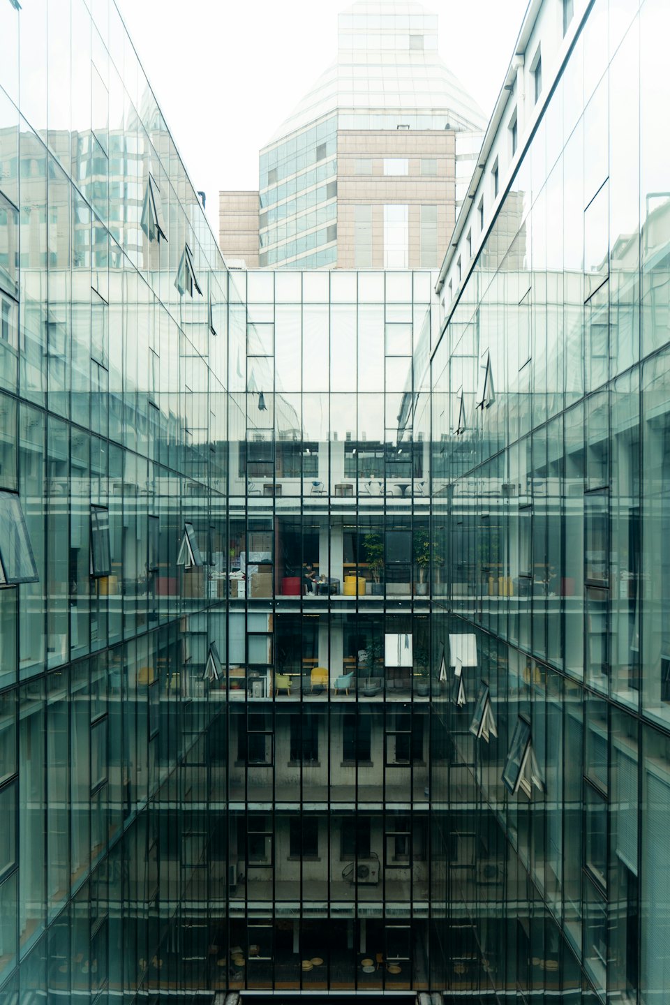 Modern glass office building with a central narrow courtyard.
